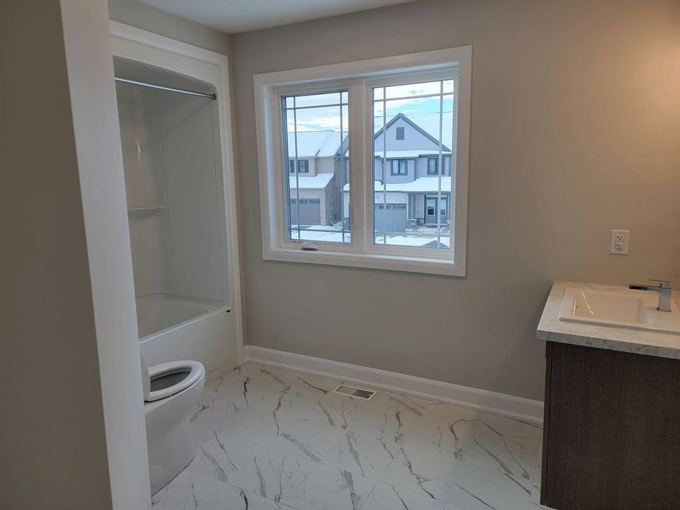 Second floor bathroom with a window over the tub