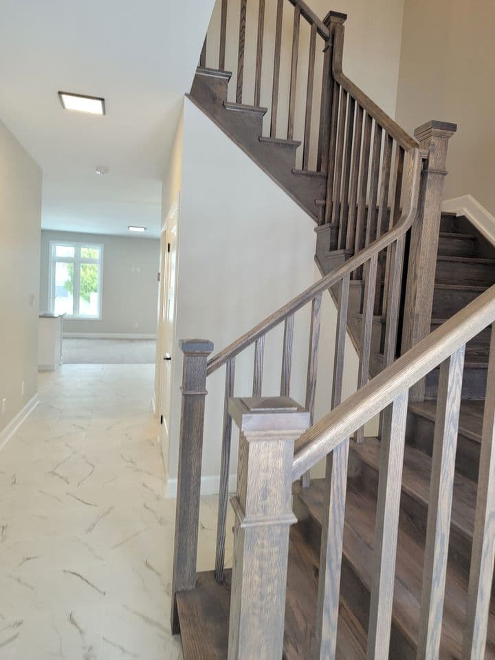 Foyer looking toward the oak staircase and the open main floor beyond